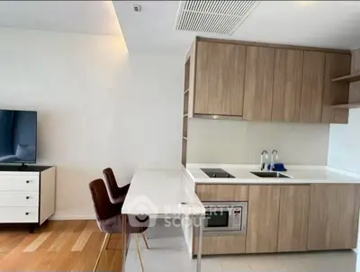 Modern kitchen with sleek cabinetry and integrated appliances in open layout.