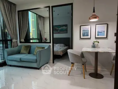Modern living room with cozy seating and elegant dining area, featuring stylish decor and natural light.