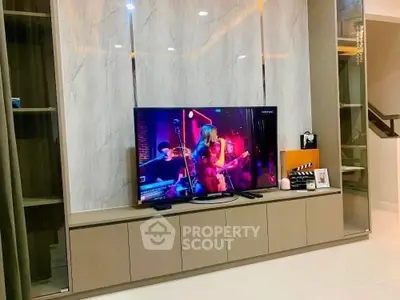 Modern living room with sleek TV unit and marble accent wall
