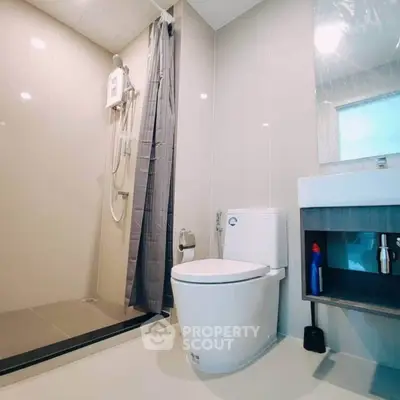 Modern bathroom with sleek shower and elegant fixtures in a contemporary apartment.