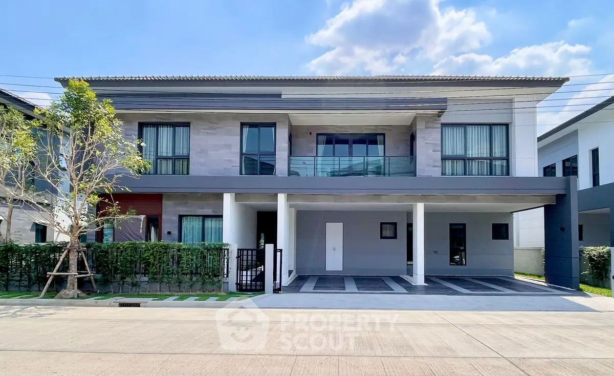 Modern two-story house with spacious driveway and sleek facade