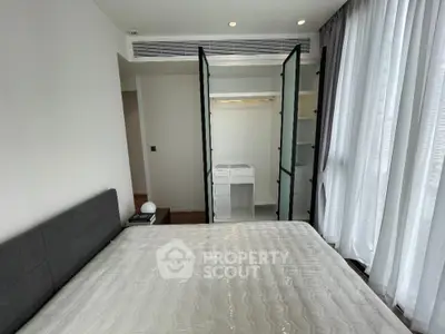 Modern bedroom with large windows and built-in closet in luxury apartment