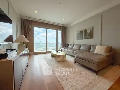 Spacious living room with panoramic city view, elegant decor, and cozy seating area.