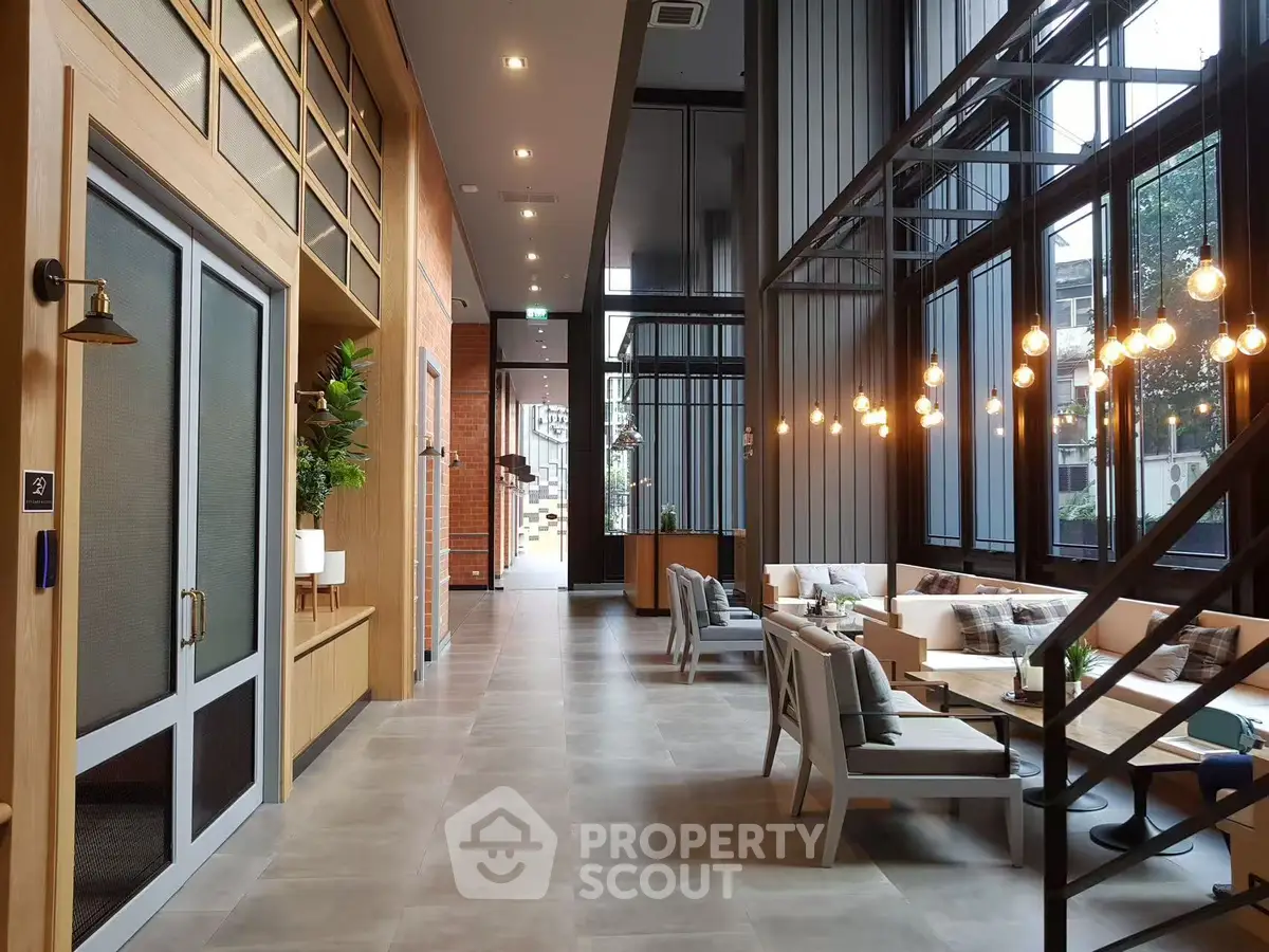Modern lobby with stylish seating and large windows in a contemporary building.