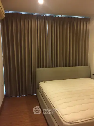 Cozy bedroom with elegant curtains and comfortable bed