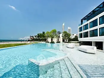 Luxurious beachfront property with stunning pool and modern architecture.