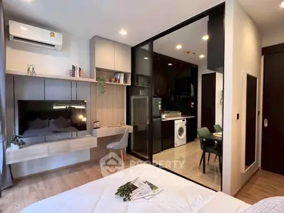 Modern studio apartment with open layout, featuring a cozy bedroom, stylish kitchen, and elegant decor.