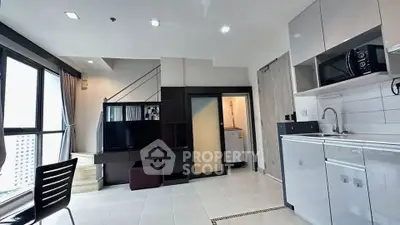 Modern open-plan living area with sleek kitchen and large windows offering city views.