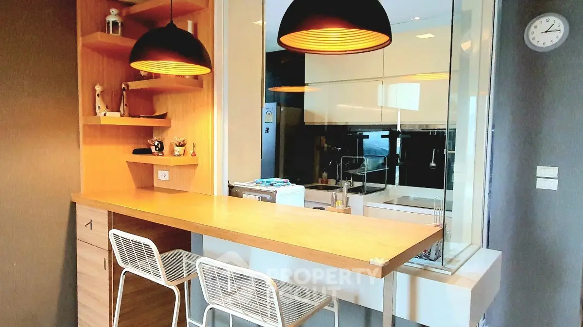 Modern kitchen with open layout and stylish breakfast bar in contemporary apartment.