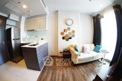 Modern open-layout living room with stylish kitchen and cozy seating area, perfect for urban living.