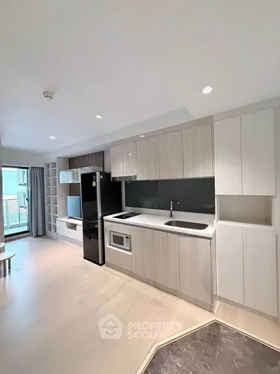 Modern open-layout kitchen with sleek appliances and spacious living area