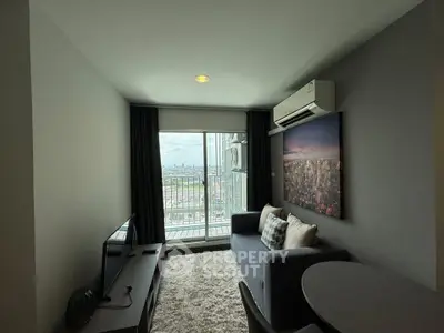Modern living room with city view, featuring a cozy sofa, TV, and air conditioning, perfect for urban living.