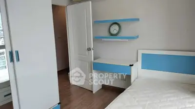 Modern bedroom with blue accents and sleek furniture design