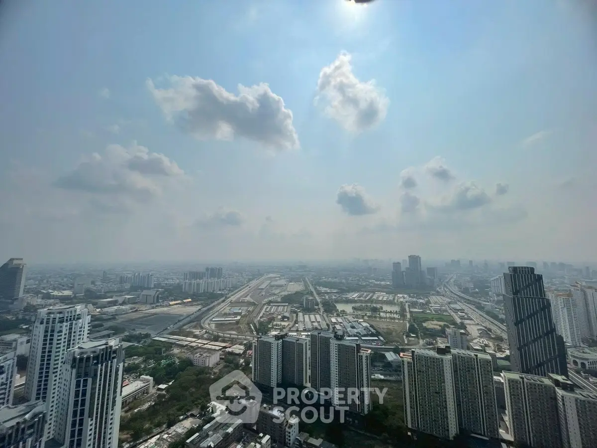 Stunning panoramic cityscape view from a high-rise building, showcasing urban skyline and expansive horizon.