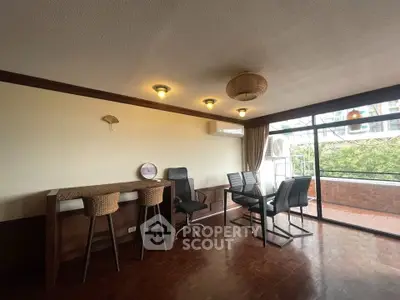 Spacious living room with balcony access and stylish seating in a modern apartment.