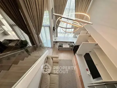 Stunning modern loft with high ceilings and elegant lighting in a luxurious living room setting.