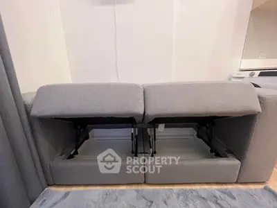 Modern gray recliner sofa with sleek design in a stylish living room setting.