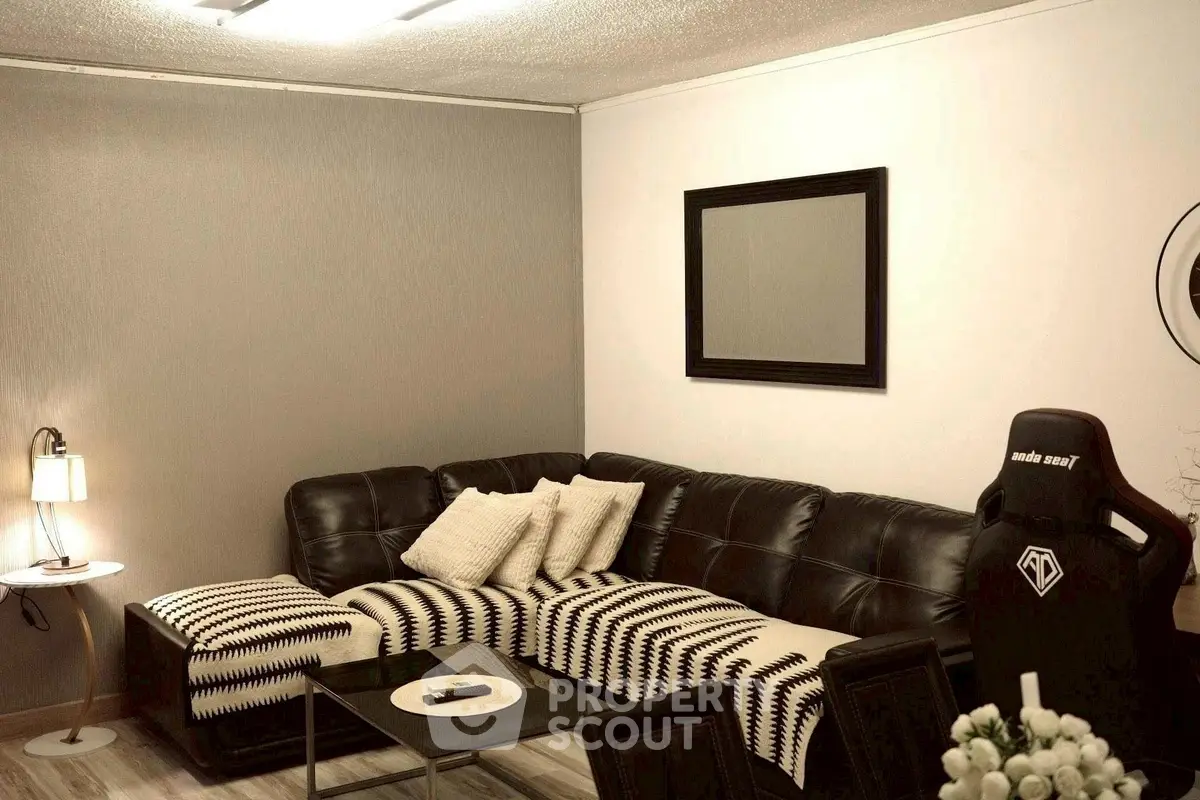 Cozy living room with stylish black leather sofa and modern decor