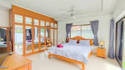 Spacious bedroom with large mirrored wardrobe and elegant decor