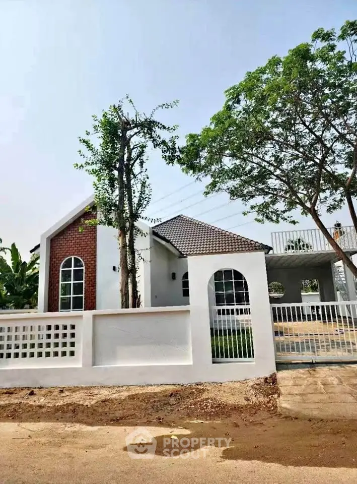 Charming single-story home with modern design and lush greenery