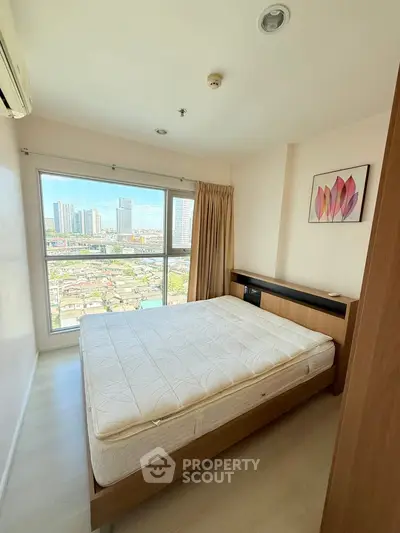 Bright bedroom with large window offering stunning city view, modern furnishings, and minimalist decor.