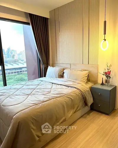 Modern bedroom with city view, elegant decor, and cozy ambiance.