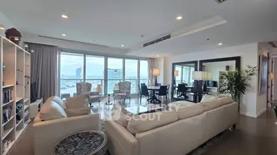 Spacious modern living room with panoramic city views and elegant furnishings.