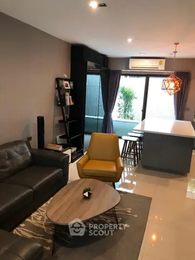 Modern living room with stylish furniture and open kitchen layout