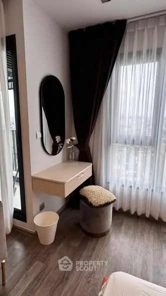 Chic bedroom corner with modern vanity and city view, perfect for urban living.