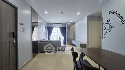 Modern living room with stylish decor and ample natural light, featuring a cozy seating area and dining space.
