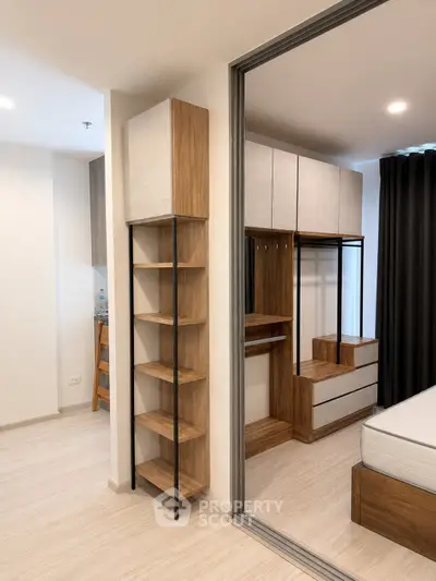 Modern bedroom with stylish wooden furniture and sliding glass partition