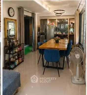 Spacious dining area with modern decor and large windows for natural light.
