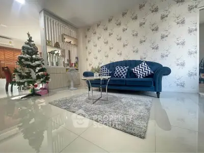 Elegant living room with stylish sofa and Christmas decor, perfect for cozy gatherings.