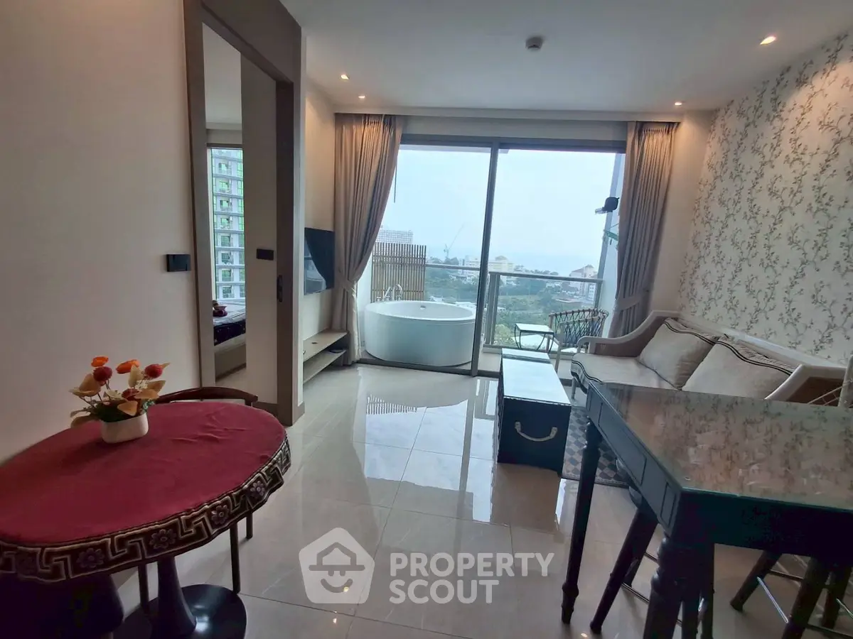 Stylish living room with balcony and bathtub view, perfect for modern living.