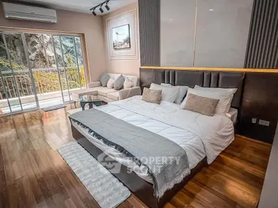 Luxurious bedroom with balcony access and stylish decor in modern apartment