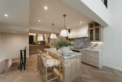 Luxurious open kitchen with marble countertops and elegant lighting