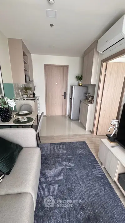 Modern apartment interior with cozy living area and compact kitchen