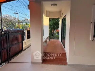 Charming exterior walkway with garden view and modern design.