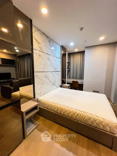Modern bedroom with stylish decor and comfortable bed in a luxury apartment.