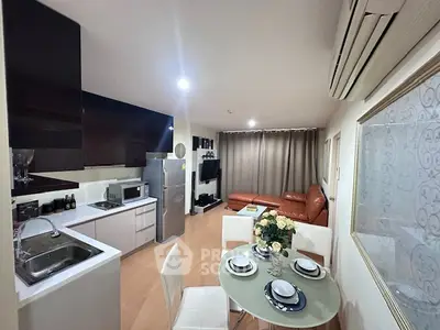 Modern open-layout kitchen and living room with stylish decor and appliances