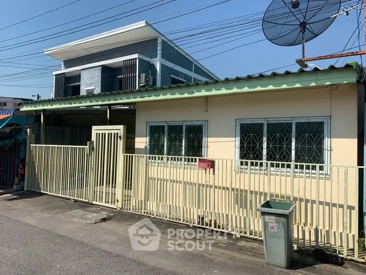 Charming single-story home with gated entrance and satellite dish, perfect for modern living.