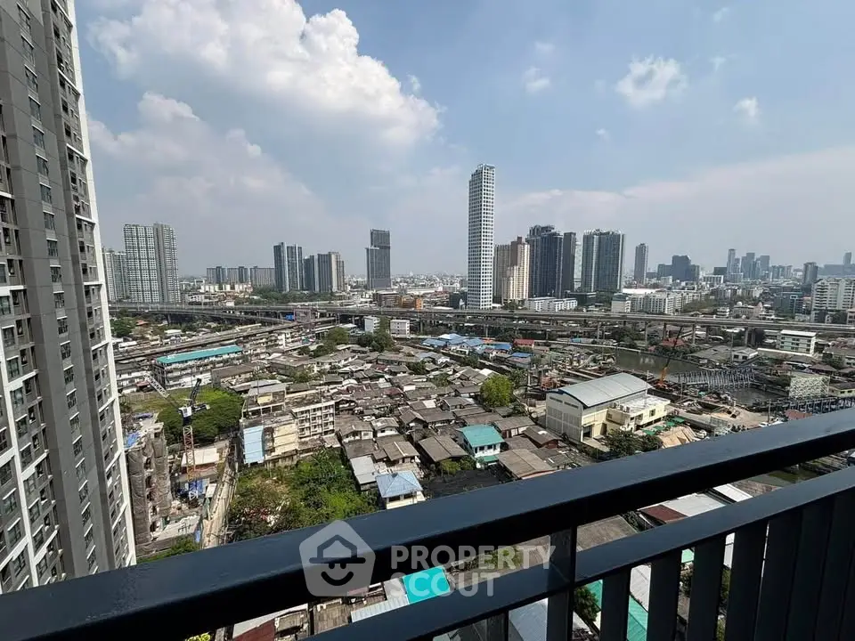 Stunning cityscape view from high-rise balcony overlooking urban skyline and residential area.