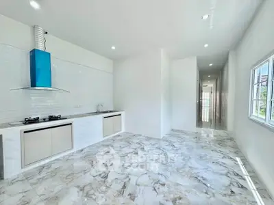 Modern kitchen with sleek marble flooring and gas stove in bright open layout