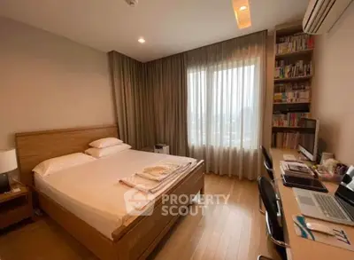 Spacious bedroom with wooden flooring, large window, and modern furnishings in a cozy apartment.
