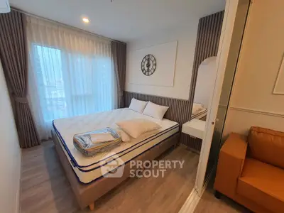 Cozy bedroom with modern decor and large window in stylish apartment