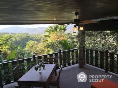 Stunning balcony with panoramic mountain views and elegant wooden decor, perfect for relaxation.