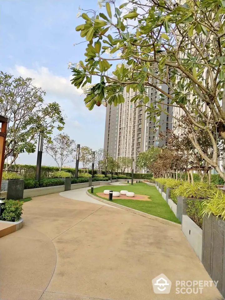 Luxurious high-rise building with landscaped garden and walking path