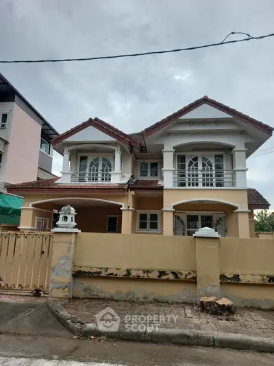 Charming two-story house with elegant balcony and classic architecture