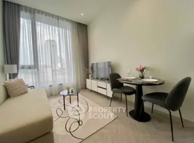 Elegant living space with modern furnishings, natural light, and a cozy dining area, perfect for urban living.