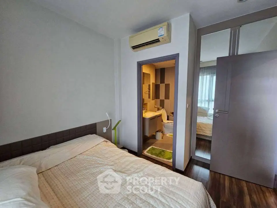 Cozy bedroom with ensuite bathroom and modern air conditioning unit